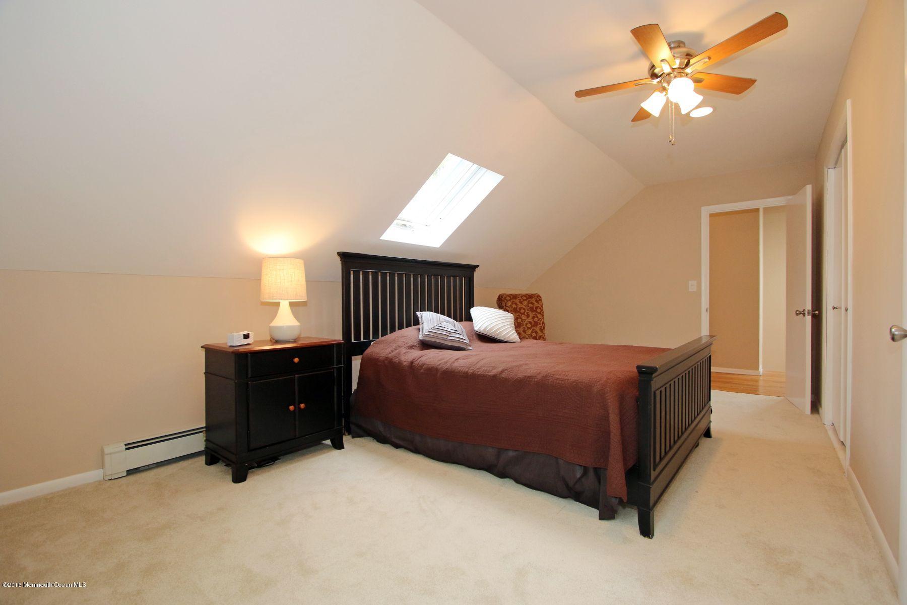 186 Pinebrook Road Tinton Falls, NJ 07724 - Photo 32 of 41 a bedroom with a bed and a ceiling fan
