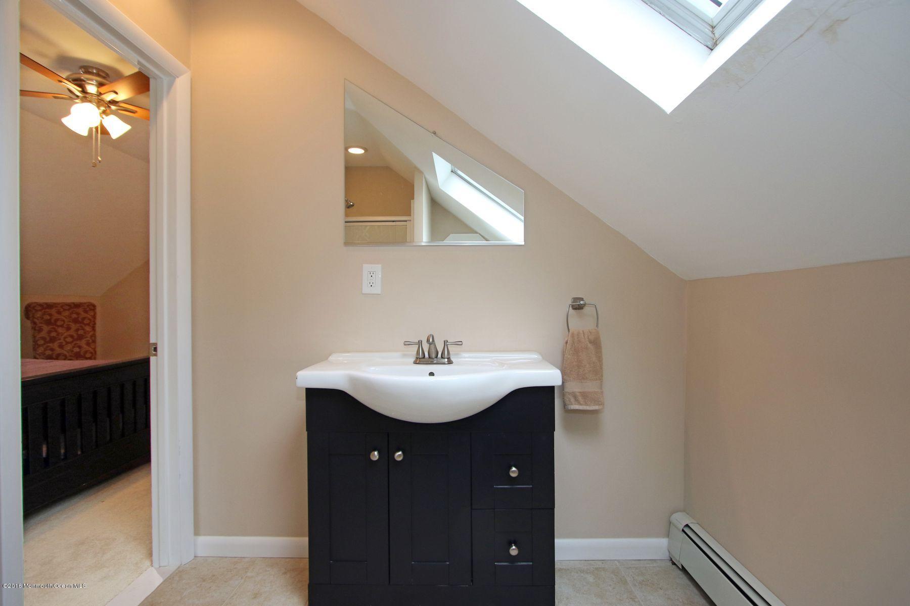 186 Pinebrook Road Tinton Falls, NJ 07724 - Photo 34 of 41 a bathroom with a sink and mirror
