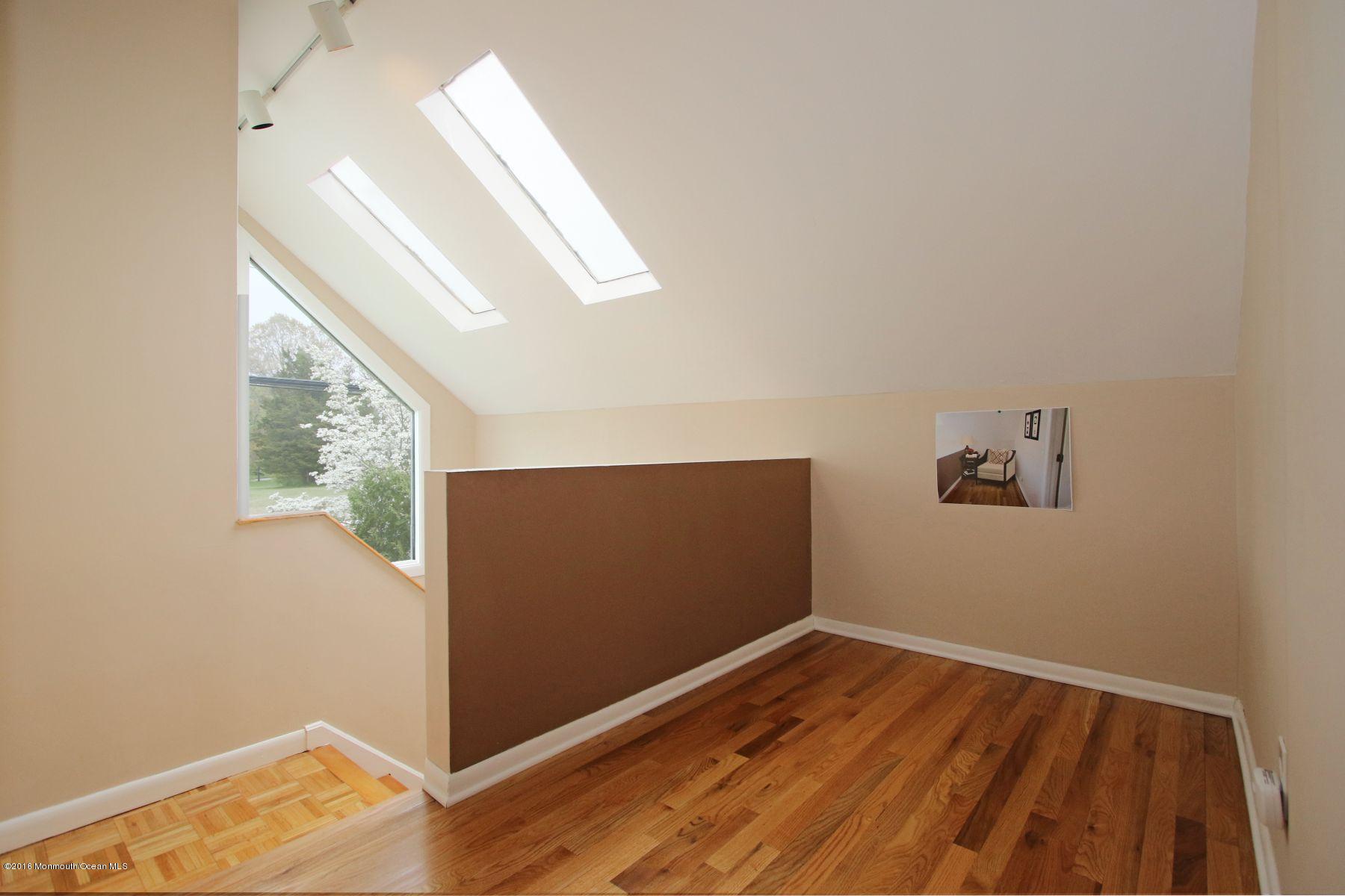 186 Pinebrook Road Tinton Falls, NJ 07724 - Photo 36 of 41 a view of room with window and wooden floor