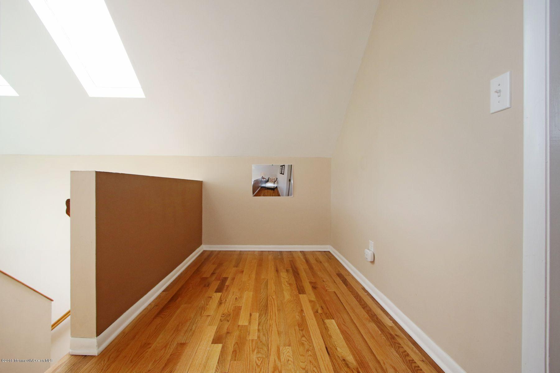 186 Pinebrook Road Tinton Falls, NJ 07724 - Photo 37 of 41 a view of wooden floor in a room
