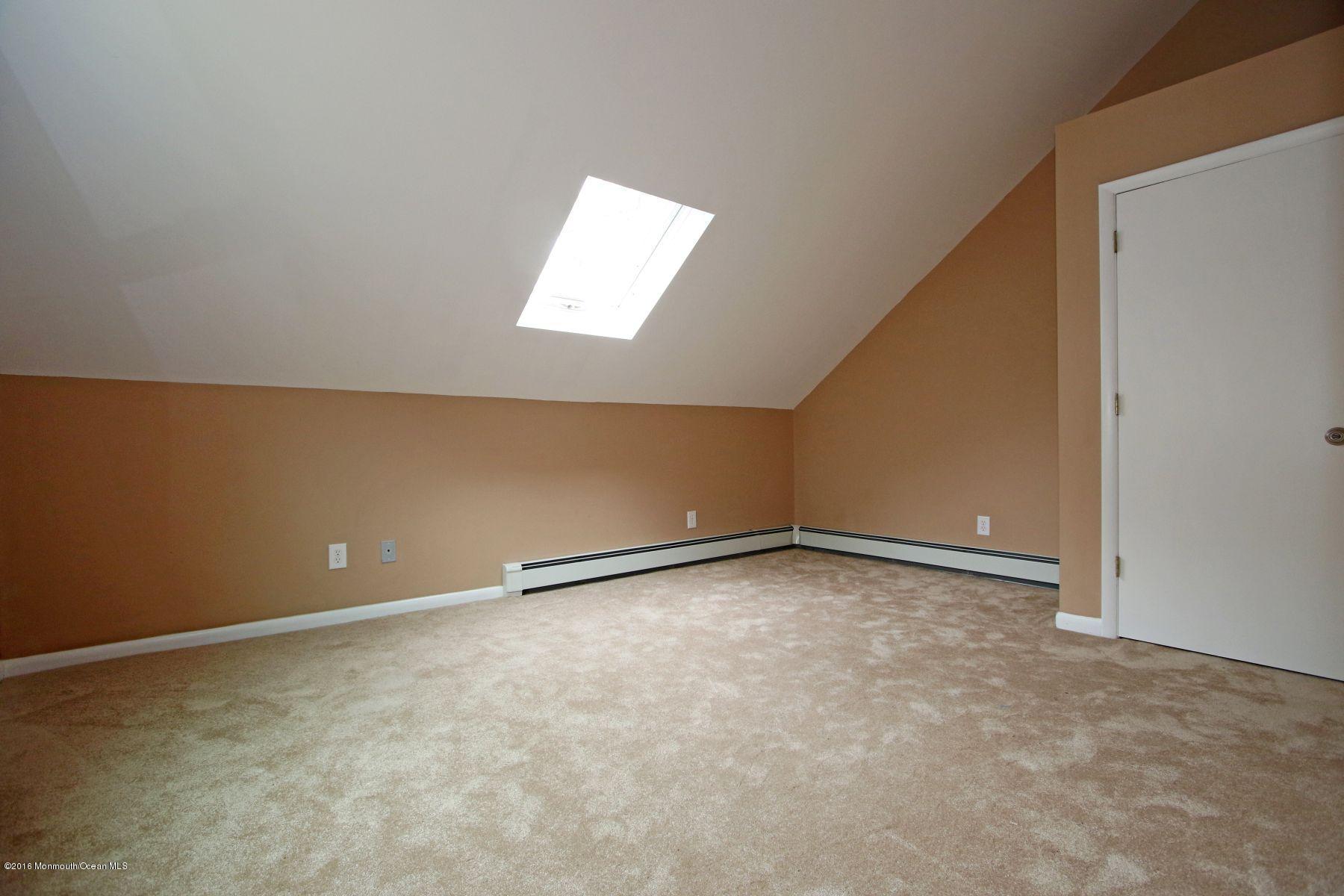 186 Pinebrook Road Tinton Falls, NJ 07724 - Photo 38 of 41 an empty room with a empty space and a window