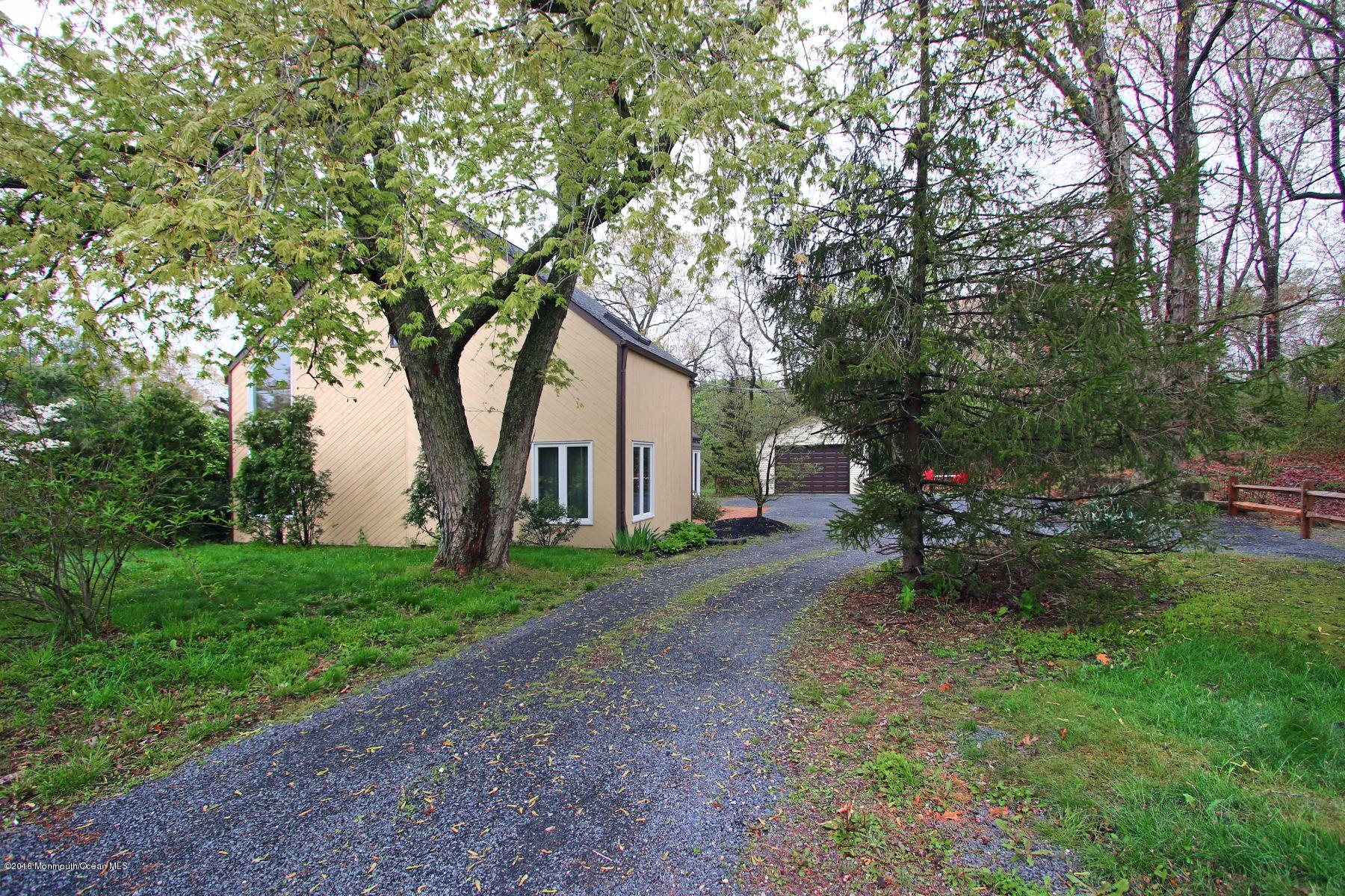 186 Pinebrook Road Tinton Falls, NJ 07724 - Photo 5 of 41 a view of a backyard with table and chairs and a large tree