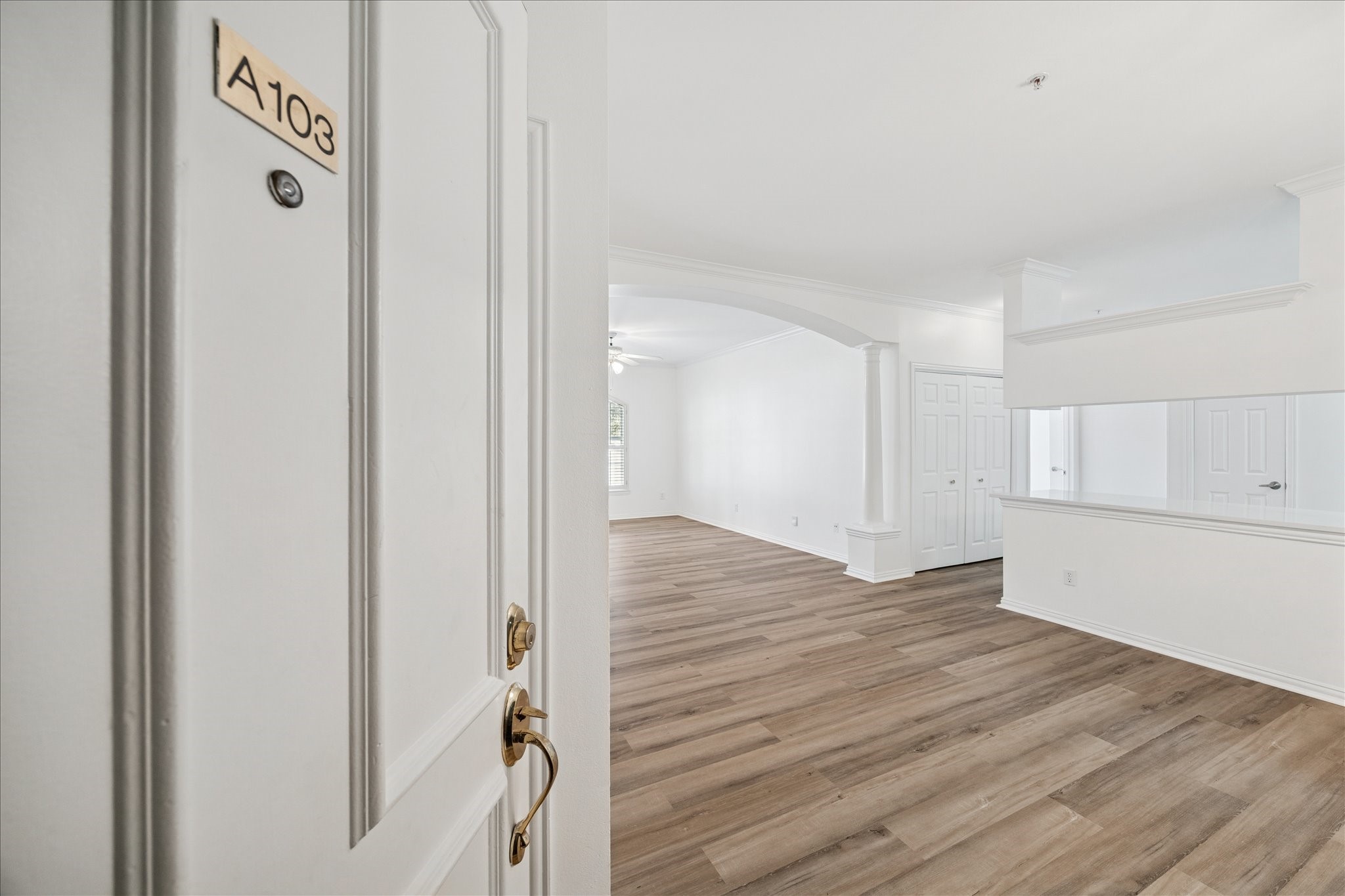 a view of a hallway with wooden floor