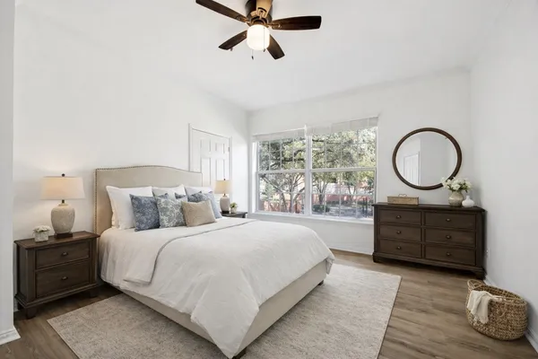 a bedroom with a large bed and a dresser