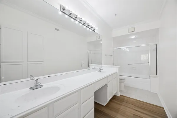 a bathroom with a sink double vanity granite tub and shower