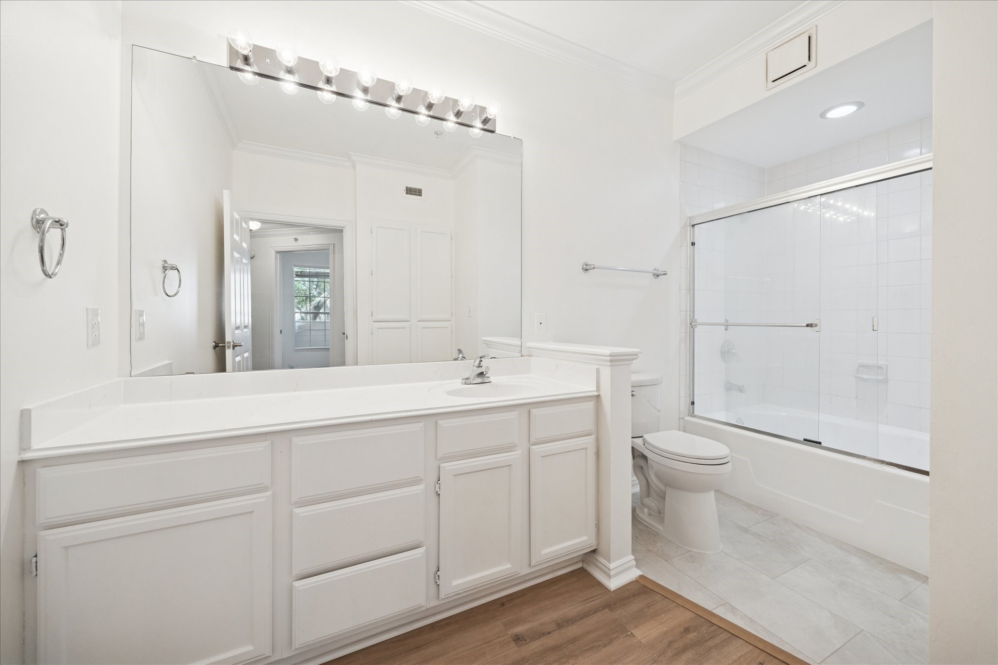 2111 Welch Street, Unit A103 Houston, TX 77019 - Photo 17 of 24 a bathroom with a toilet a sink and mirror