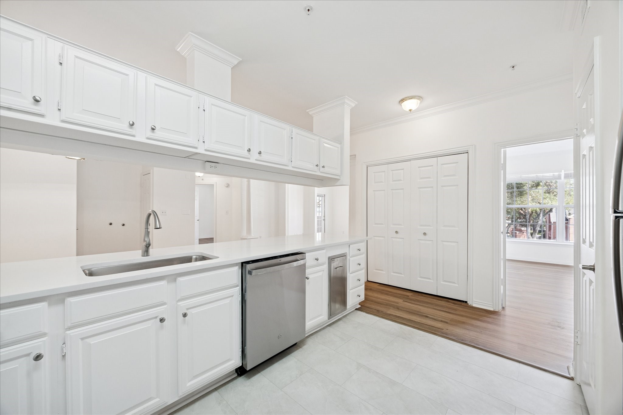 2111 Welch Street, Unit A103 Houston, TX 77019 - Photo 6 of 24 a kitchen with a sink and cabinets