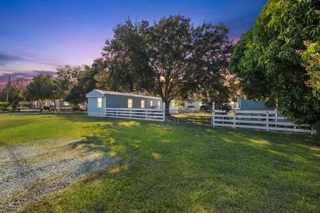 a view of house with garden space and trees