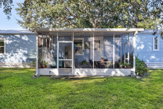 a living room with furniture kitchen view and a flat screen tv
