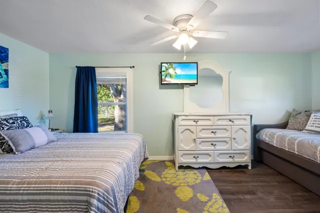 a view of a patio with table and chairs under an umbrella next to a yard