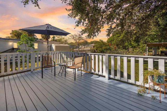 a kitchen with stainless steel appliances granite countertop dining table chairs refrigerator and sink