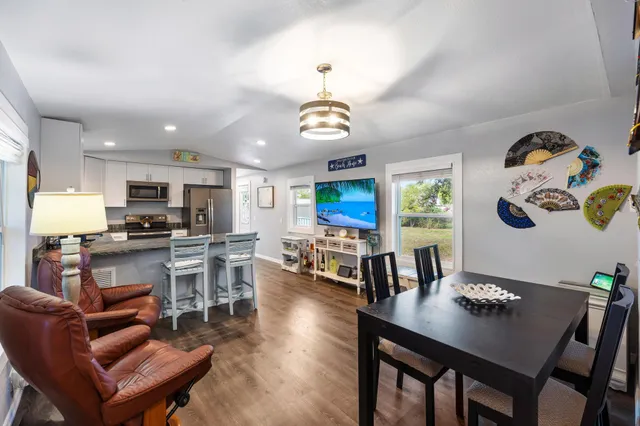 a kitchen with granite countertop stainless steel appliances a stove sink and microwave