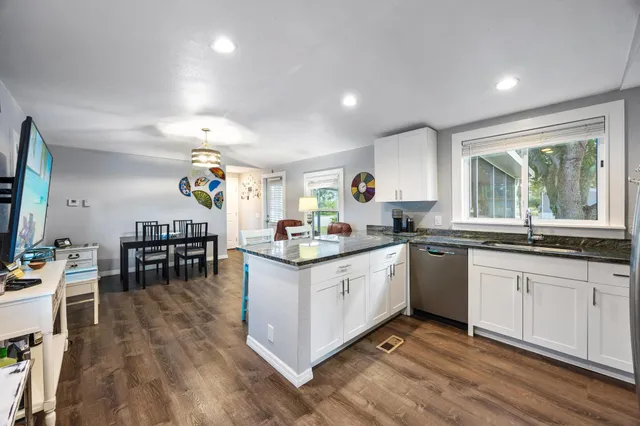 a bedroom with a bed and a flat tv screen