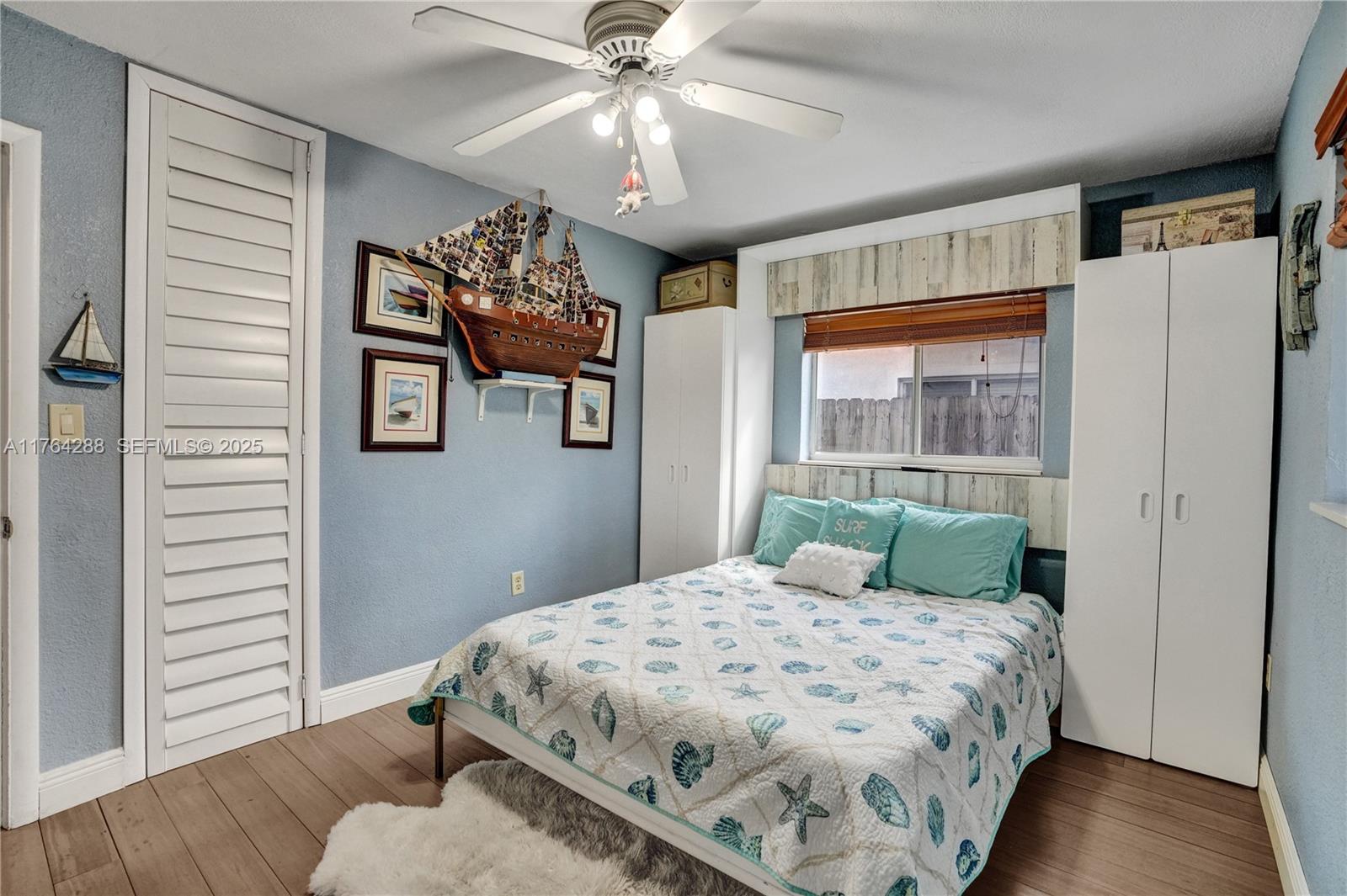 7825 Northwest 174th Street Hialeah, FL 33015 - Photo 12 of 30 a bedroom with a large bed and a chandelier