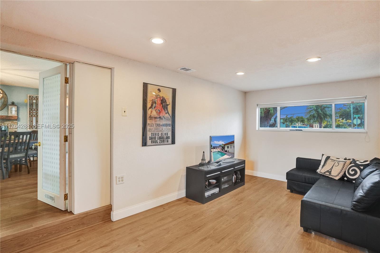 7825 Northwest 174th Street Hialeah, FL 33015 - Photo 18 of 30 a living room with furniture and a wooden floor