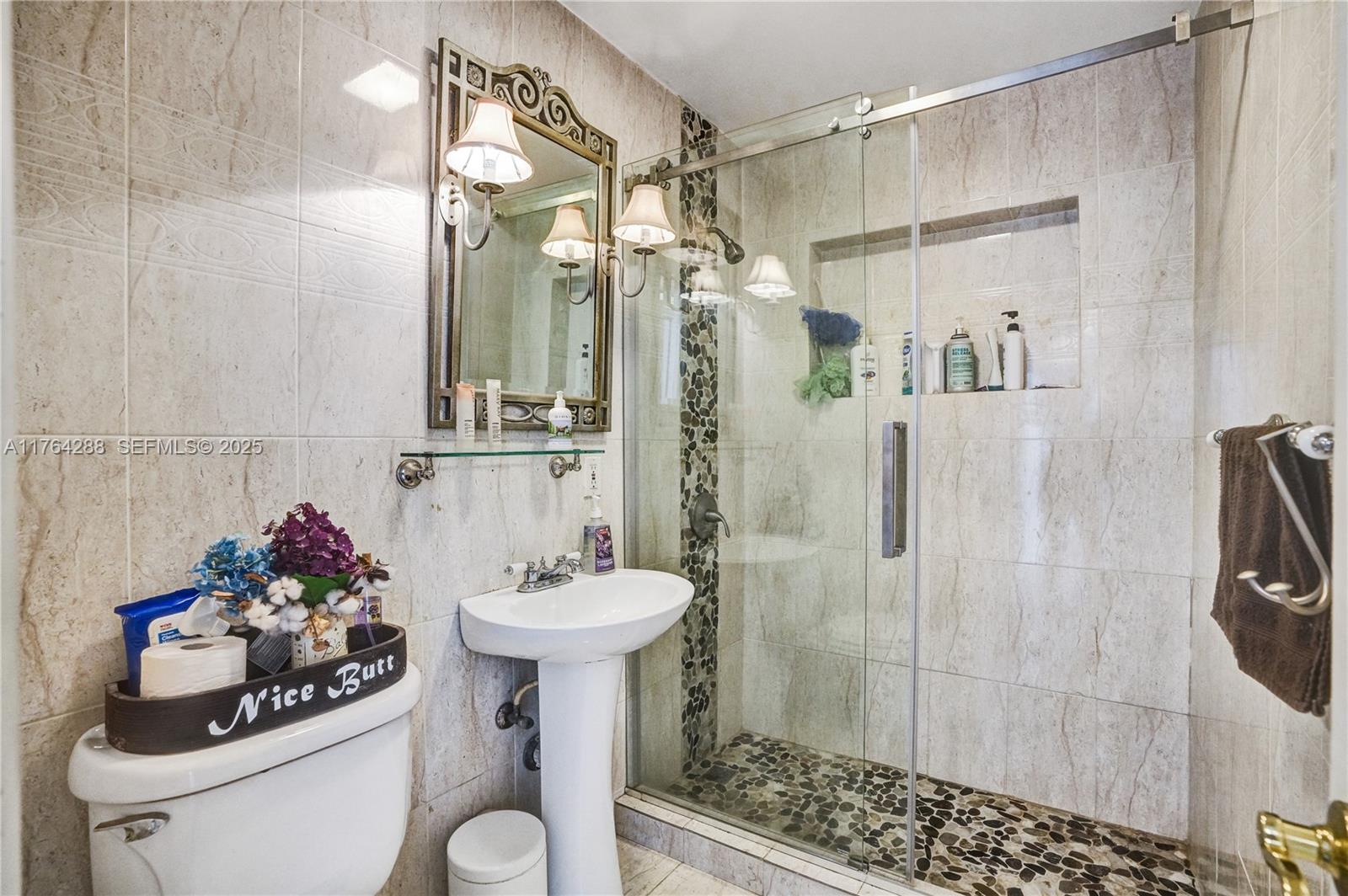 7825 Northwest 174th Street Hialeah, FL 33015 - Photo 19 of 30 a bathroom with a sink toilet and shower