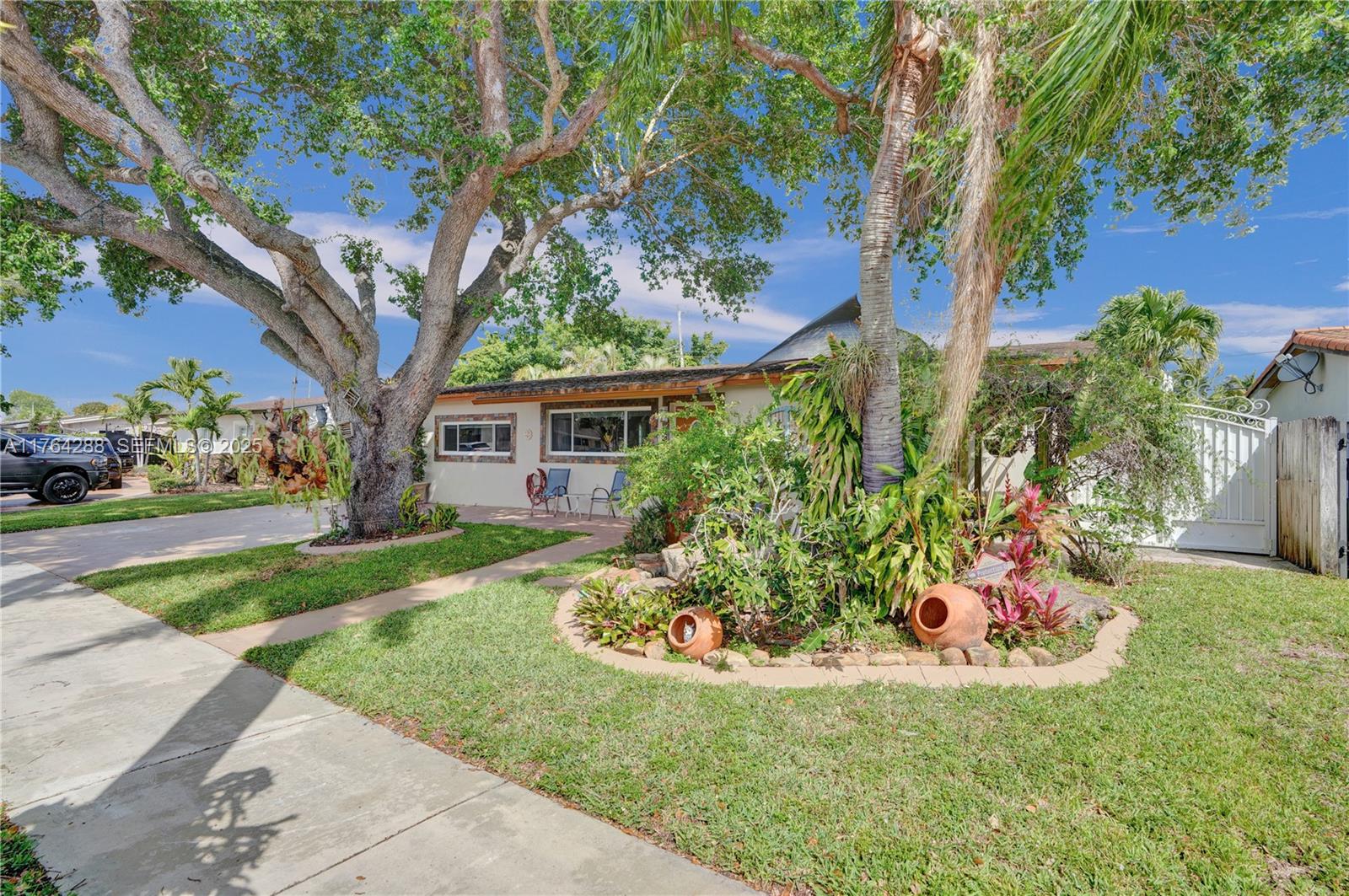 7825 Northwest 174th Street Hialeah, FL 33015 - Photo 29 of 30 a front view of a house with a yard
