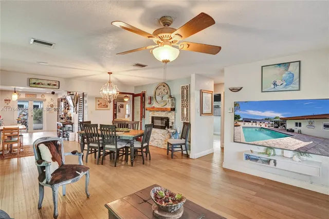 a living room with lots of furniture and view of kitchen