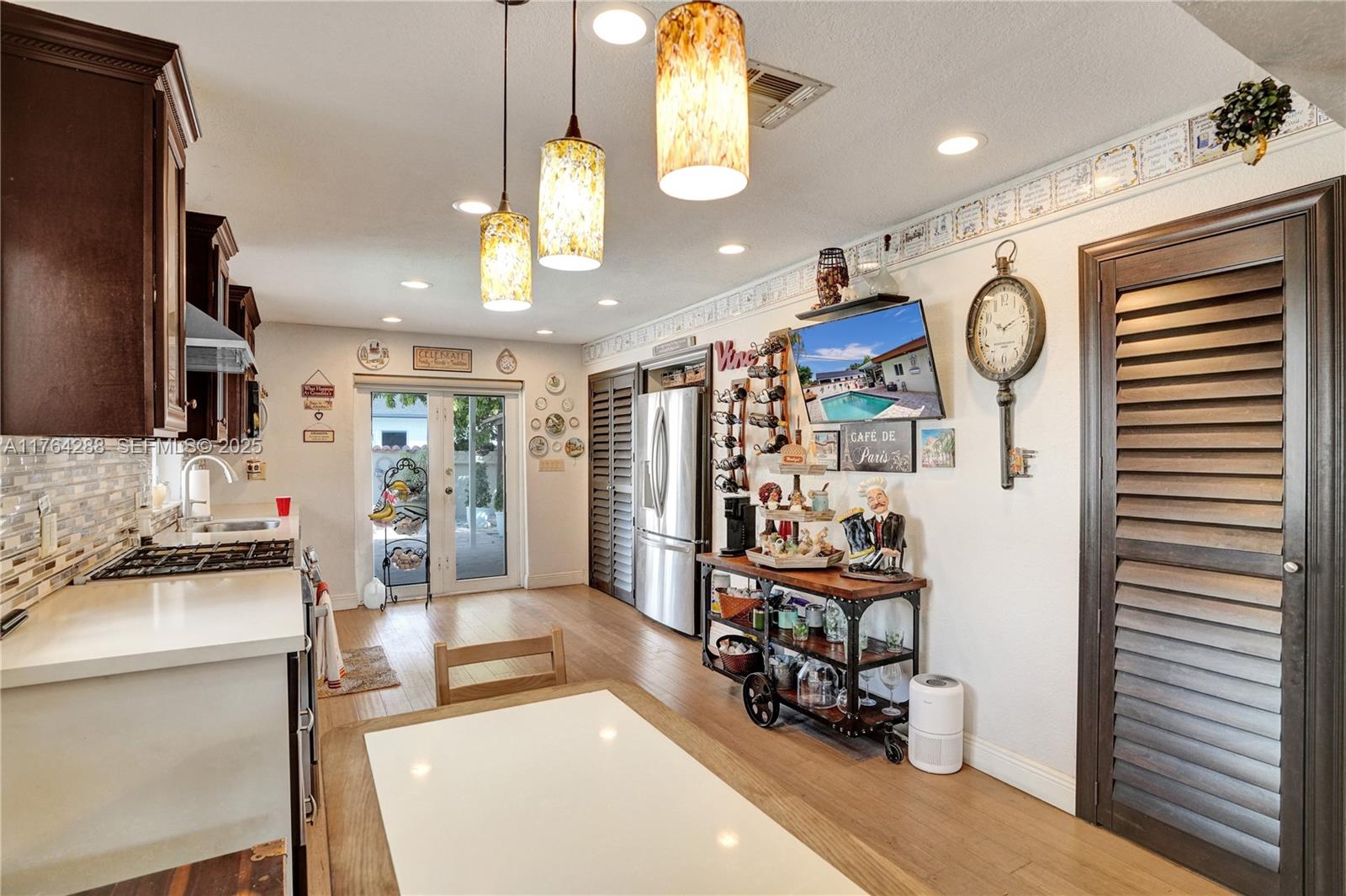 7825 Northwest 174th Street Hialeah, FL 33015 - Photo 6 of 30 a very nice looking room with a large window and chandelier