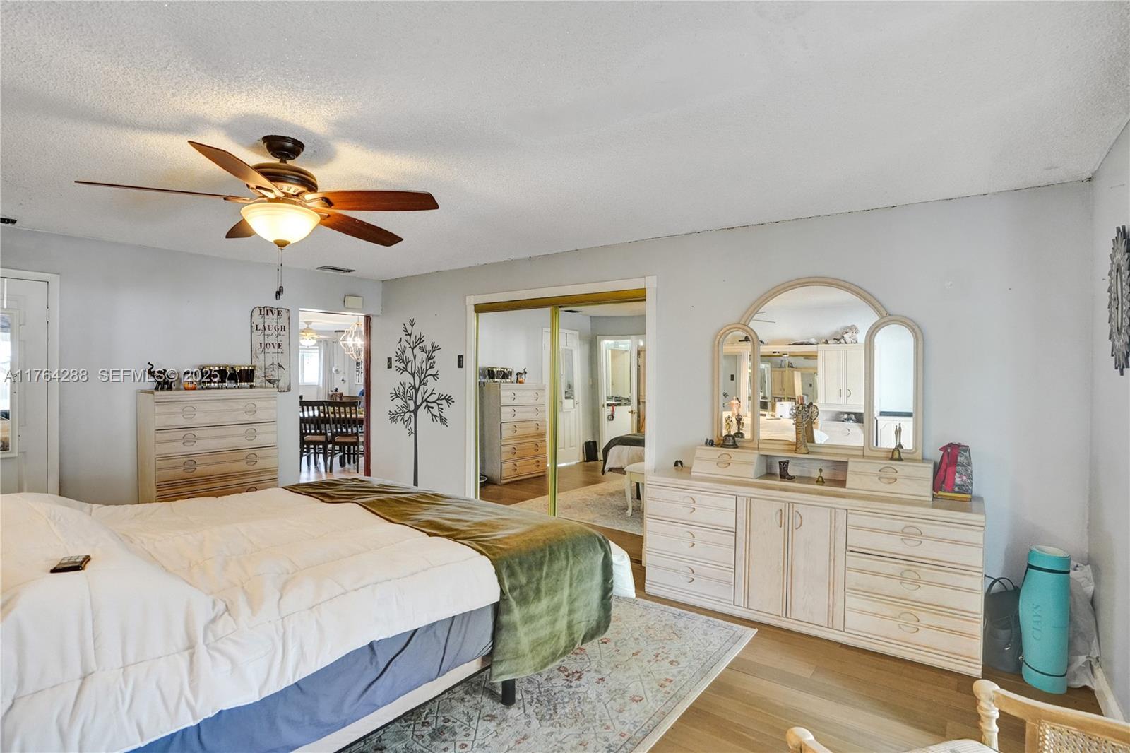 7825 Northwest 174th Street Hialeah, FL 33015 - Photo 9 of 30 a spacious bedroom with a bed and ceiling fan