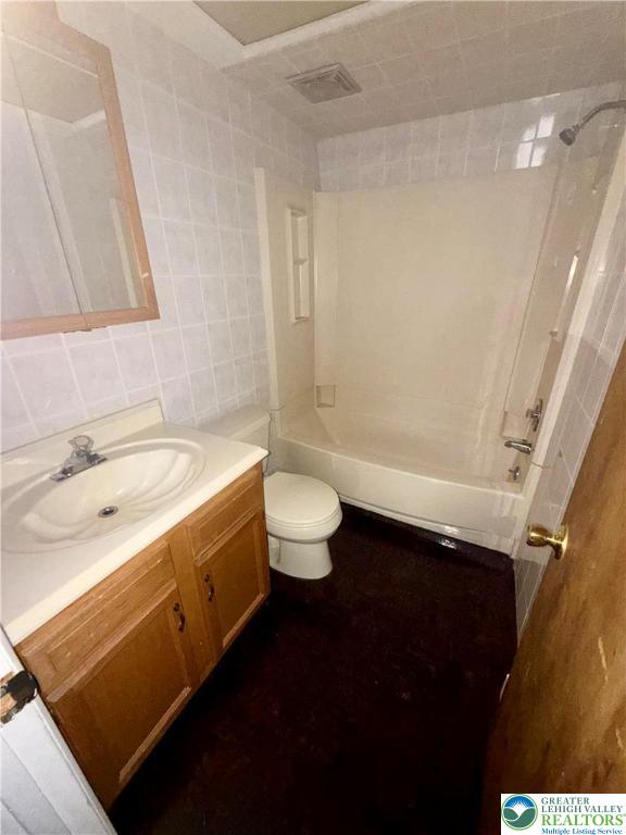 630 Greene Court Fountain Hill, PA 18015 - Photo 7 of 13 a bathroom with a granite countertop sink a toilet a shower and a mirror