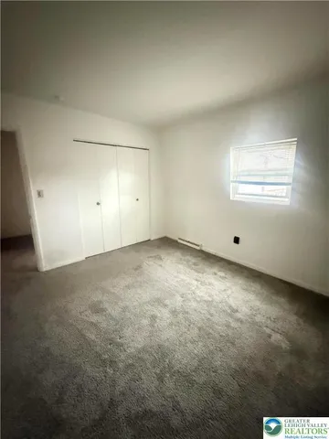 an empty room with a empty space and windows