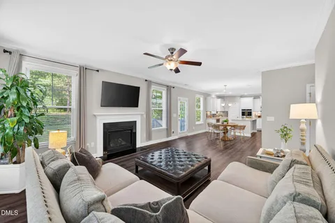 a living room with furniture fireplace and flat screen tv