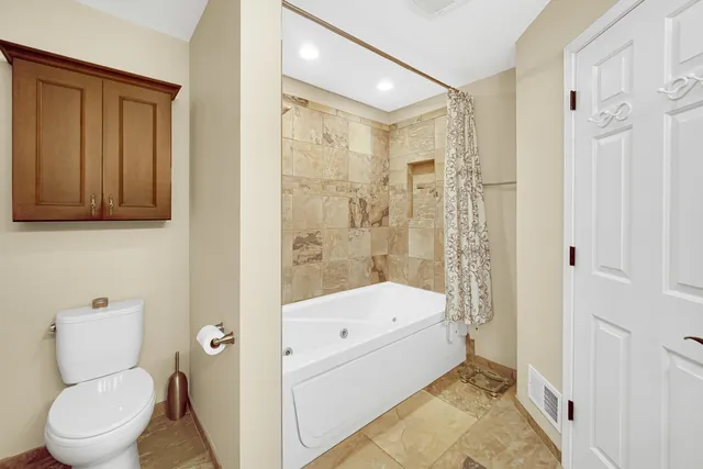 a bathroom with a toilet sink and shower