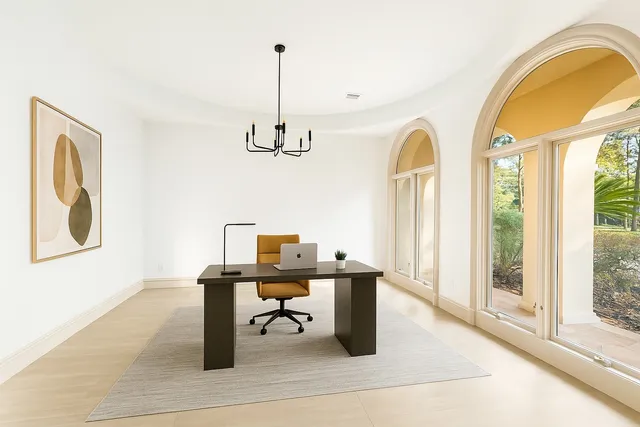 a view of a workspace with furniture and window