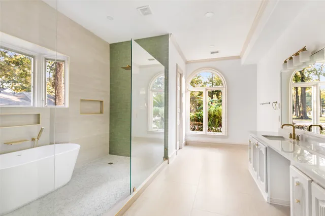 a spacious bathroom with a tub and a large window