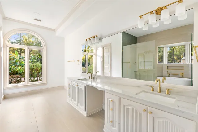 a bathroom with a granite countertop sink and a large mirror