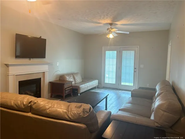 a living room with furniture and a fireplace