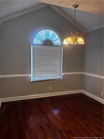 a view of room with wooden floor and window
