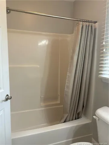 a bathroom with a shower and a toilet