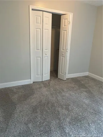a kitchen with granite countertop a refrigerator and a sink