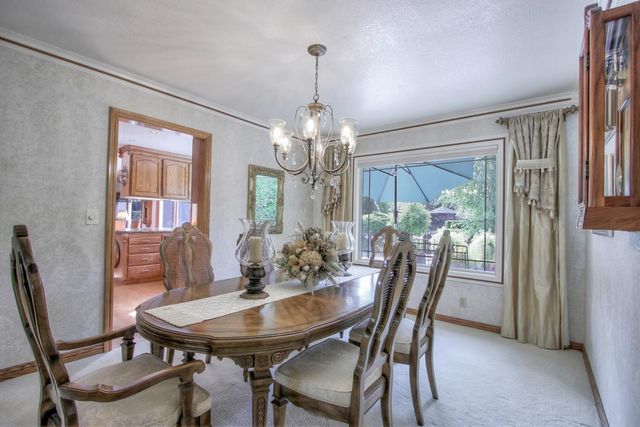 a view of a dining room with furniture and window