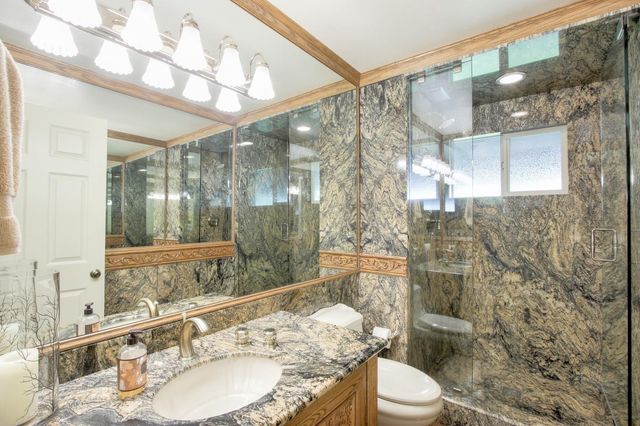 a bathroom with a sink toilet and shower