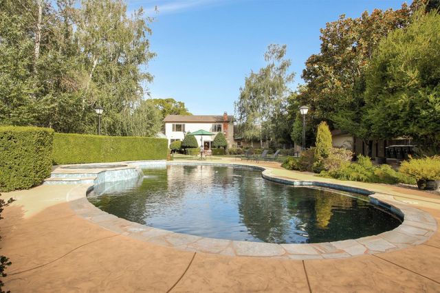 a view of a swimming pool with a yard