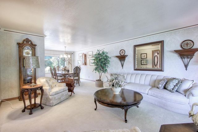 a living room with furniture and a large mirror