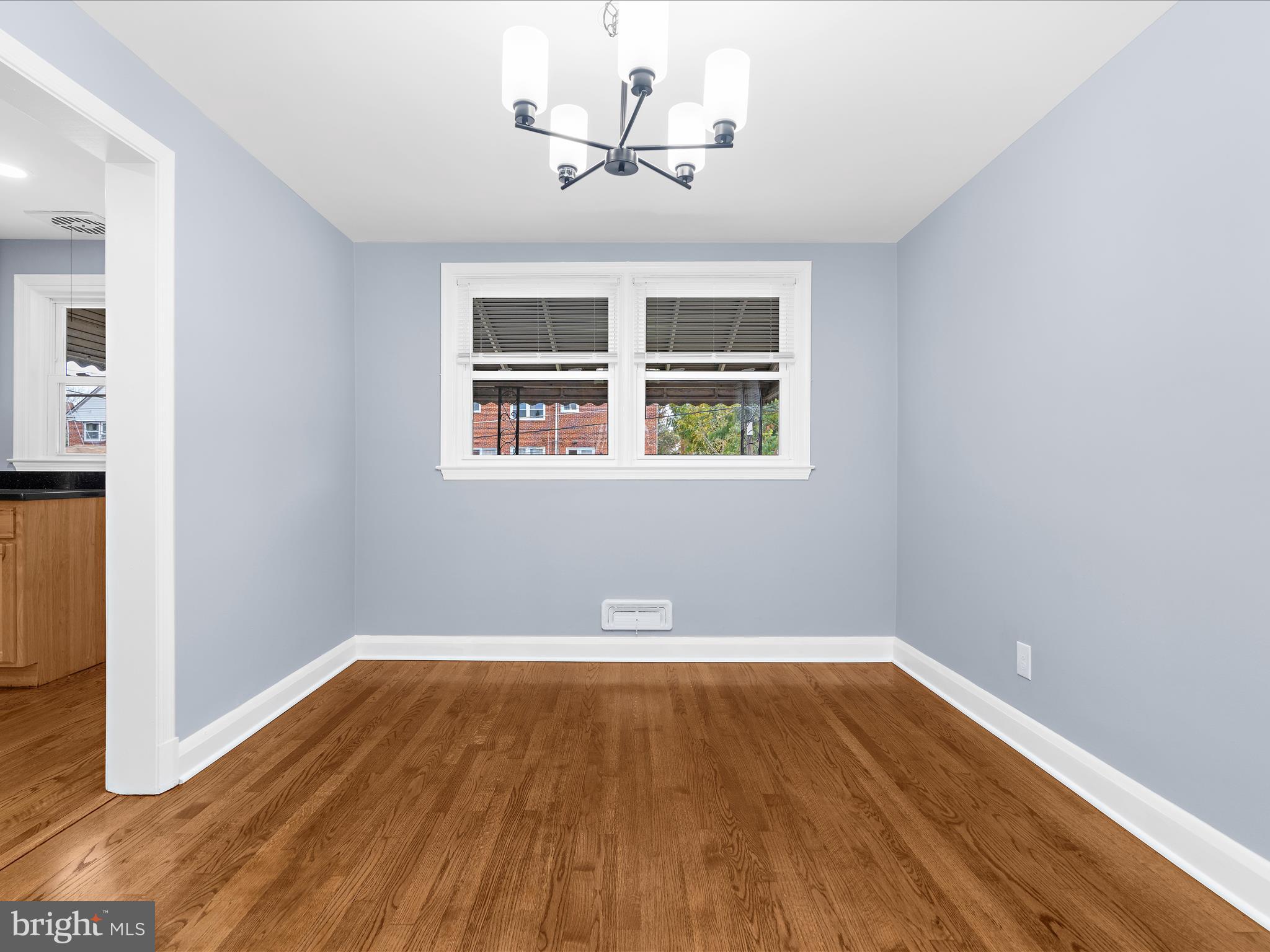 1427 Barrett Road Baltimore, MD 21207 - Photo 13 of 40 an empty room with wooden floor and windows