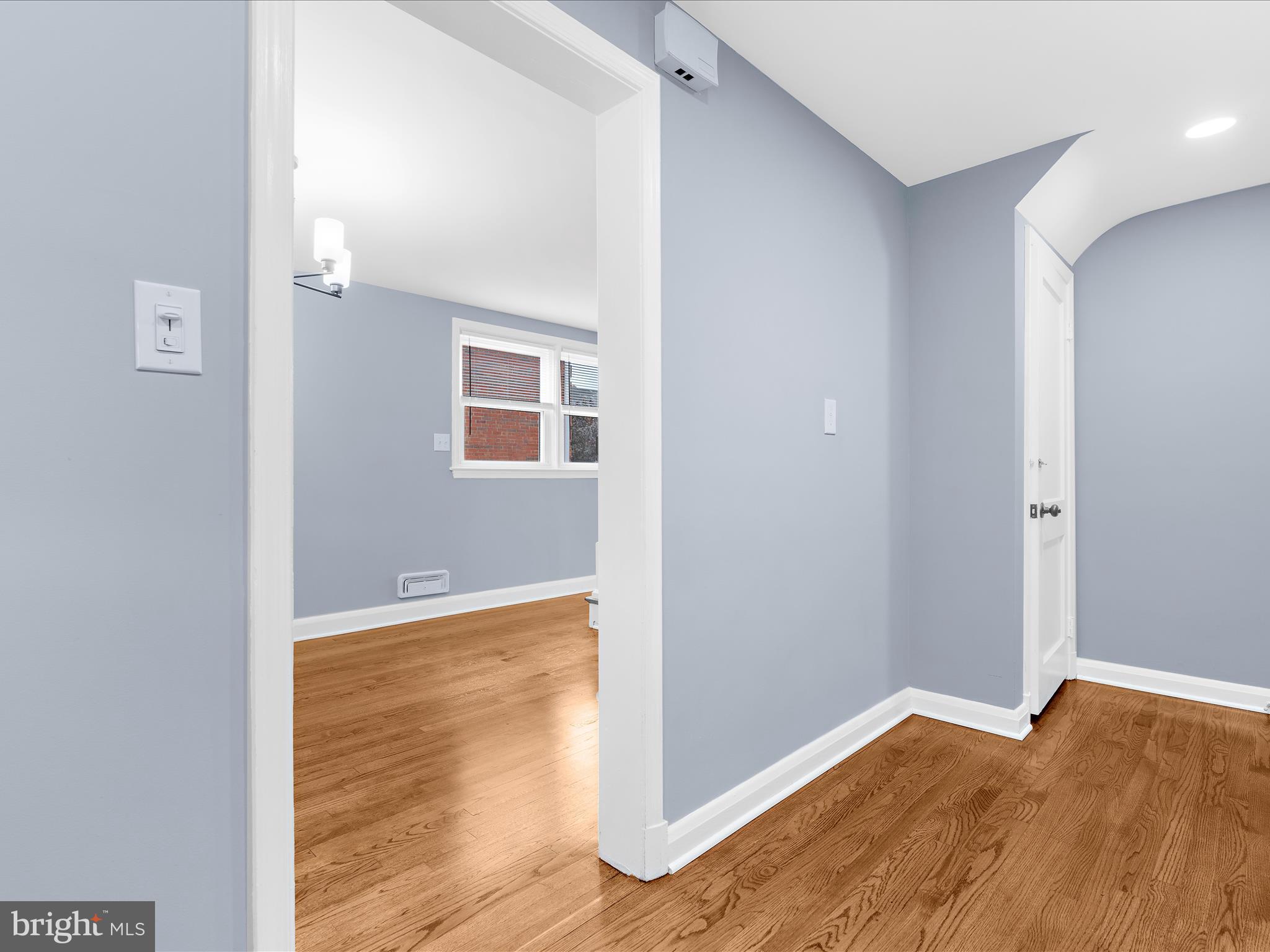 1427 Barrett Road Baltimore, MD 21207 - Photo 14 of 40 a view of an empty room with wooden floor and a window