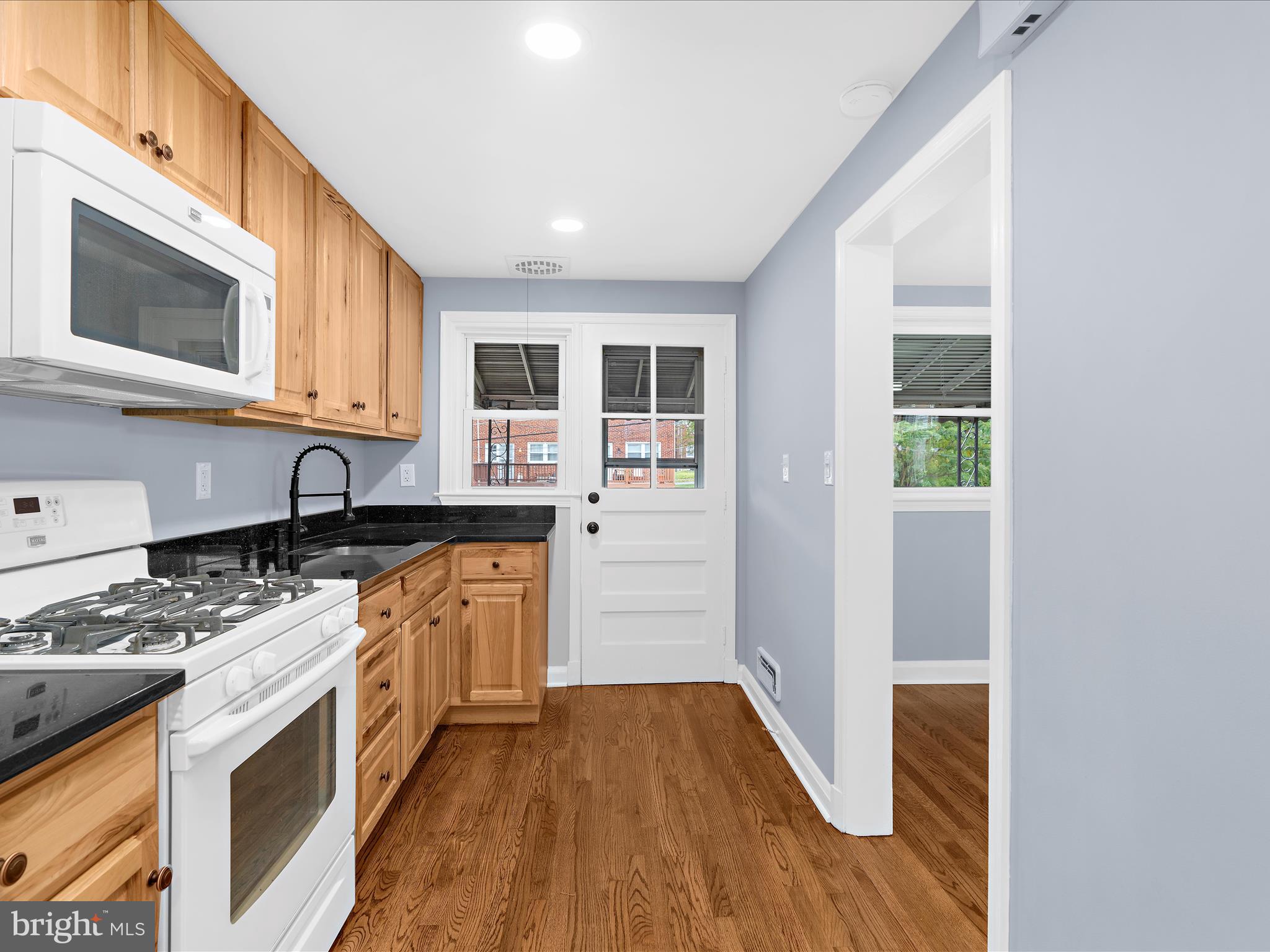 1427 Barrett Road Baltimore, MD 21207 - Photo 17 of 40 a kitchen with stainless steel appliances granite countertop a stove and a sink