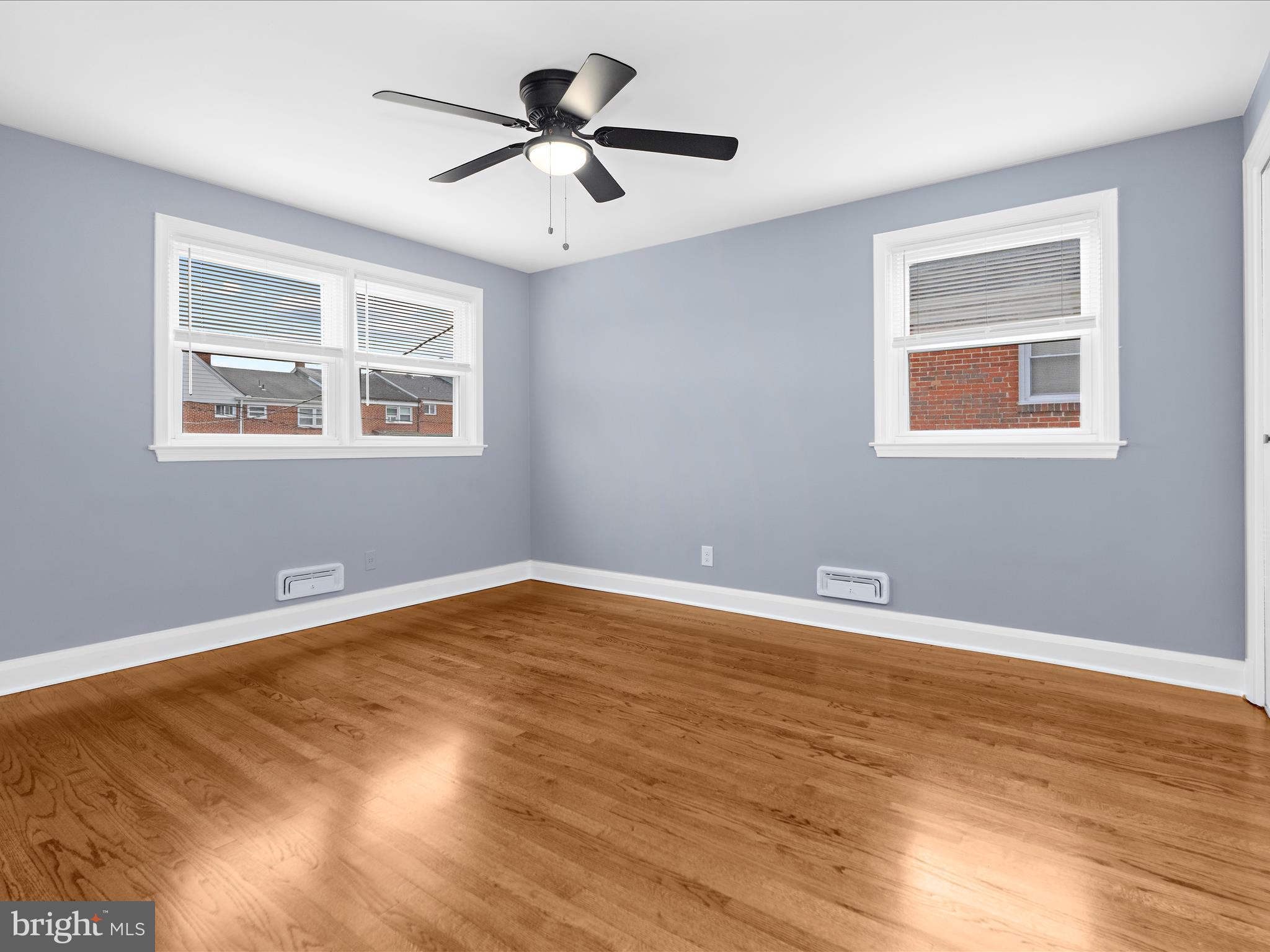 1427 Barrett Road Baltimore, MD 21207 - Photo 19 of 40 a view of an empty room with a window and wooden floor