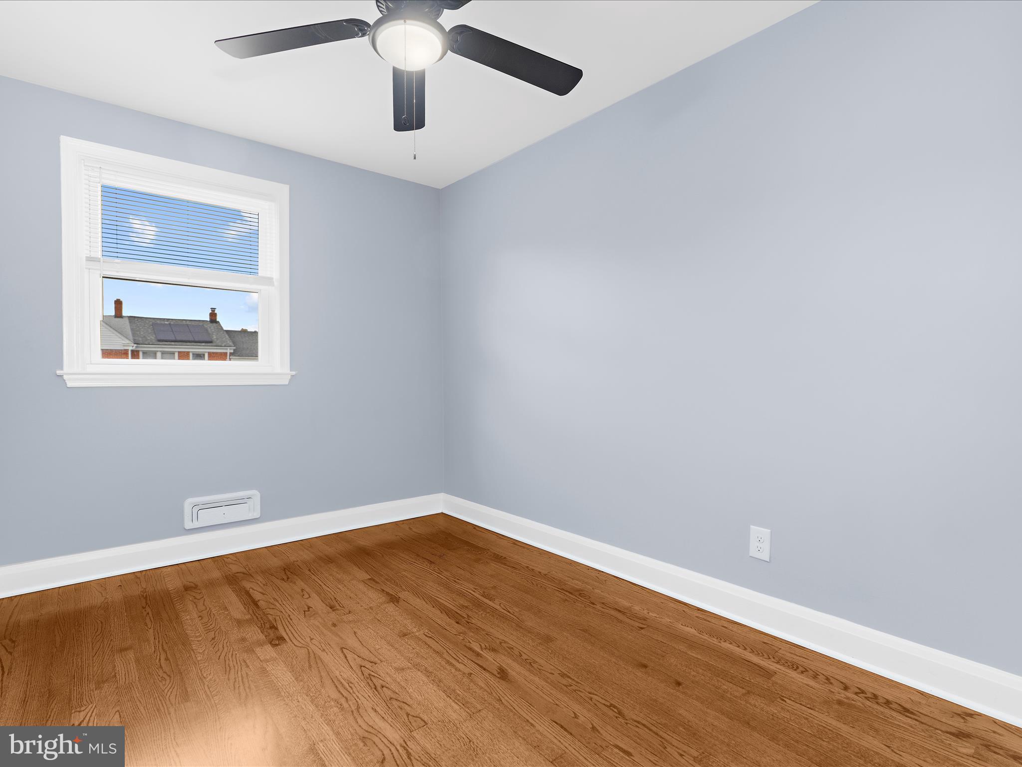 1427 Barrett Road Baltimore, MD 21207 - Photo 20 of 40 wooden floor in an empty room with a window