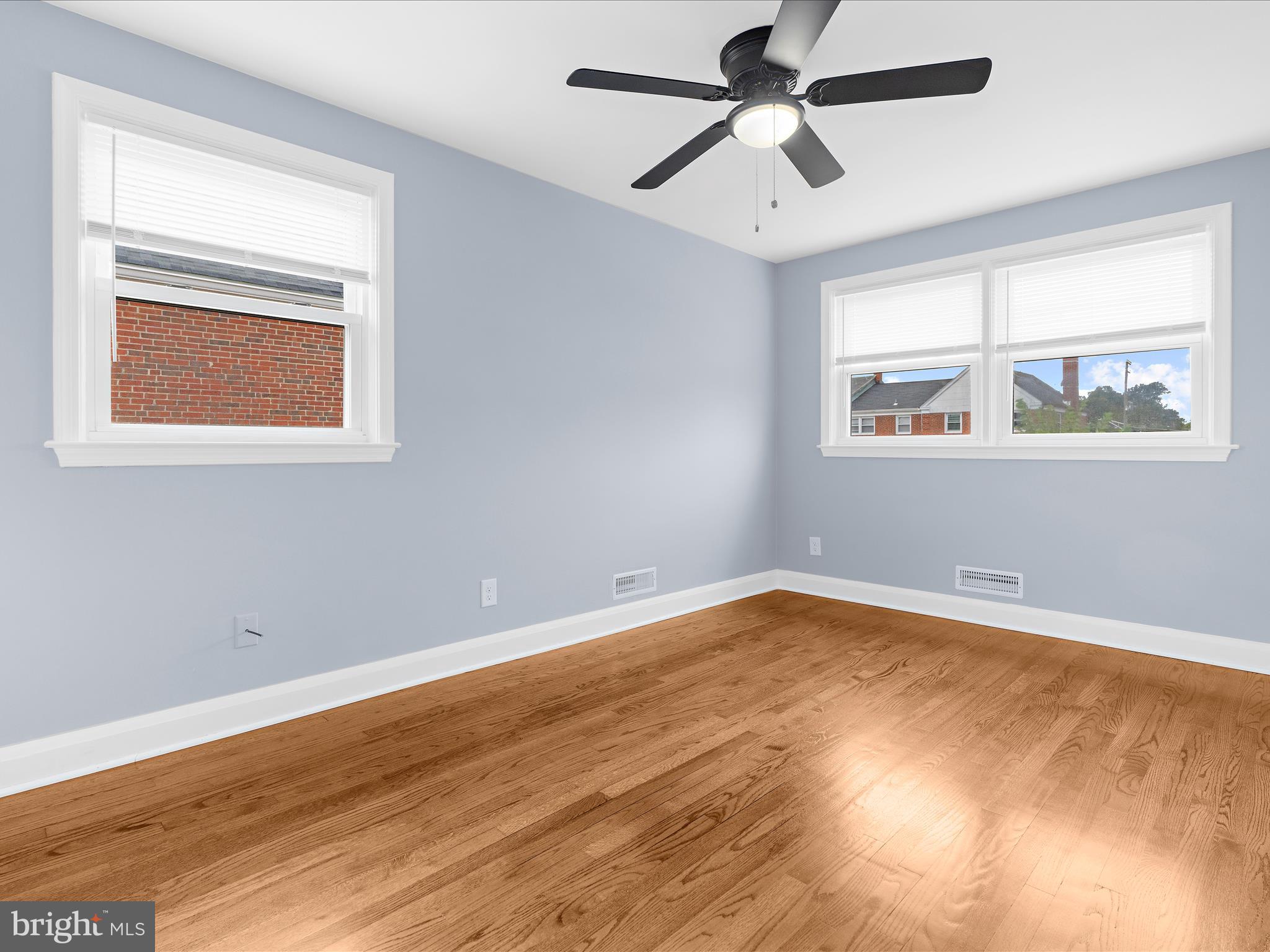 1427 Barrett Road Baltimore, MD 21207 - Photo 21 of 40 a view of an empty room with wooden floor and a window