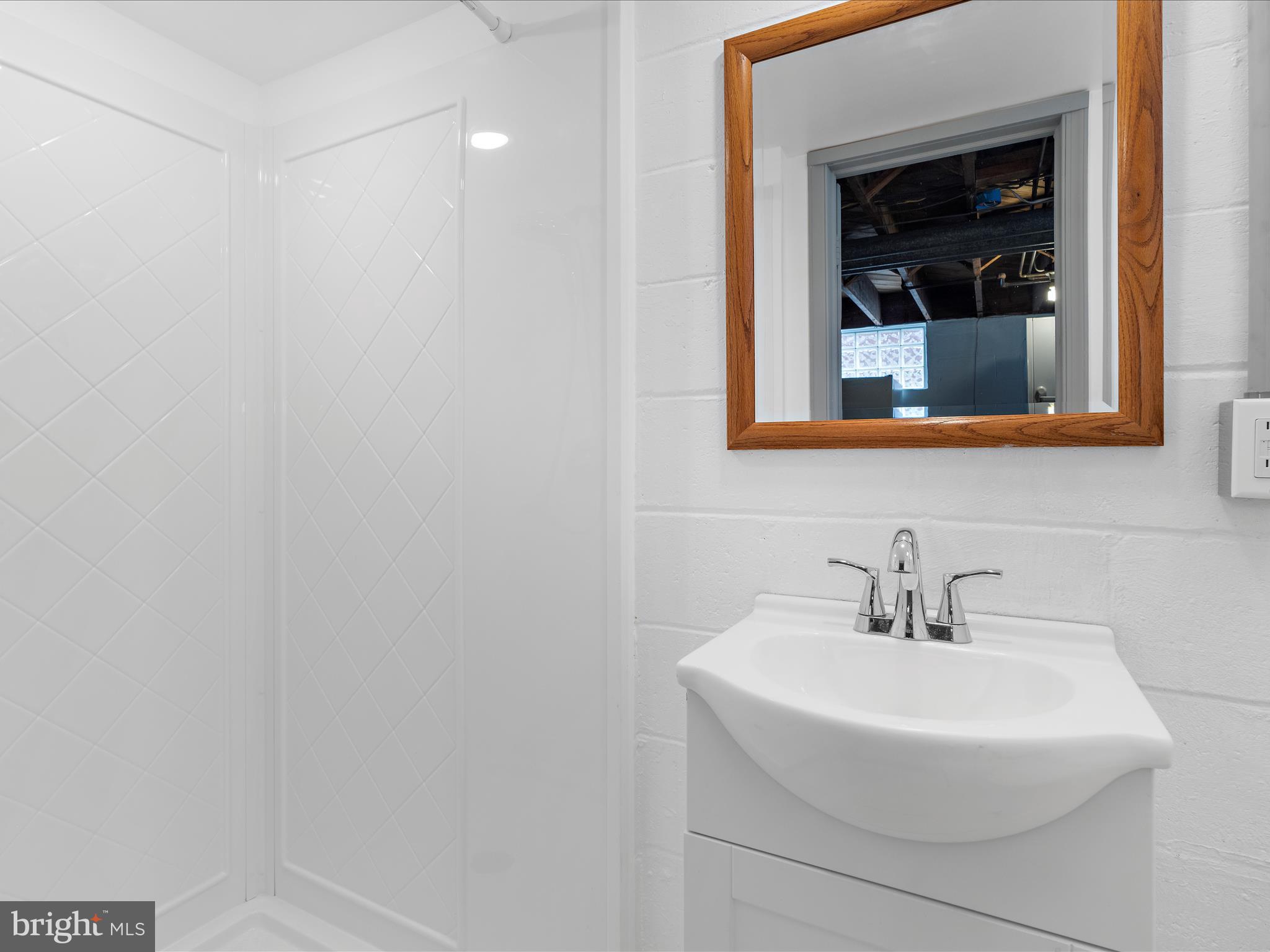 1427 Barrett Road Baltimore, MD 21207 - Photo 26 of 40 a bathroom with a sink and a mirror
