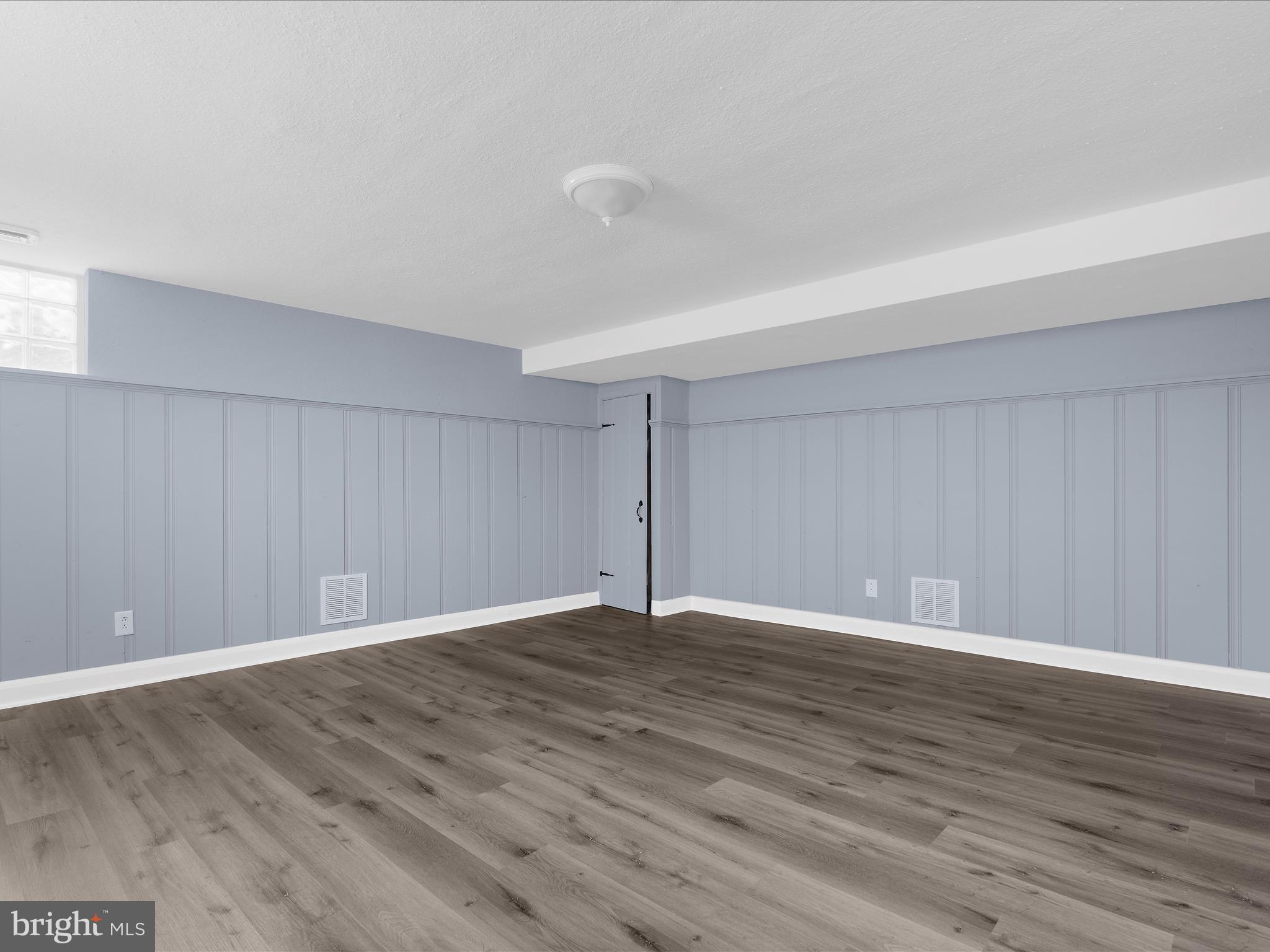 1427 Barrett Road Baltimore, MD 21207 - Photo 29 of 40 a view of an empty room with wooden floor