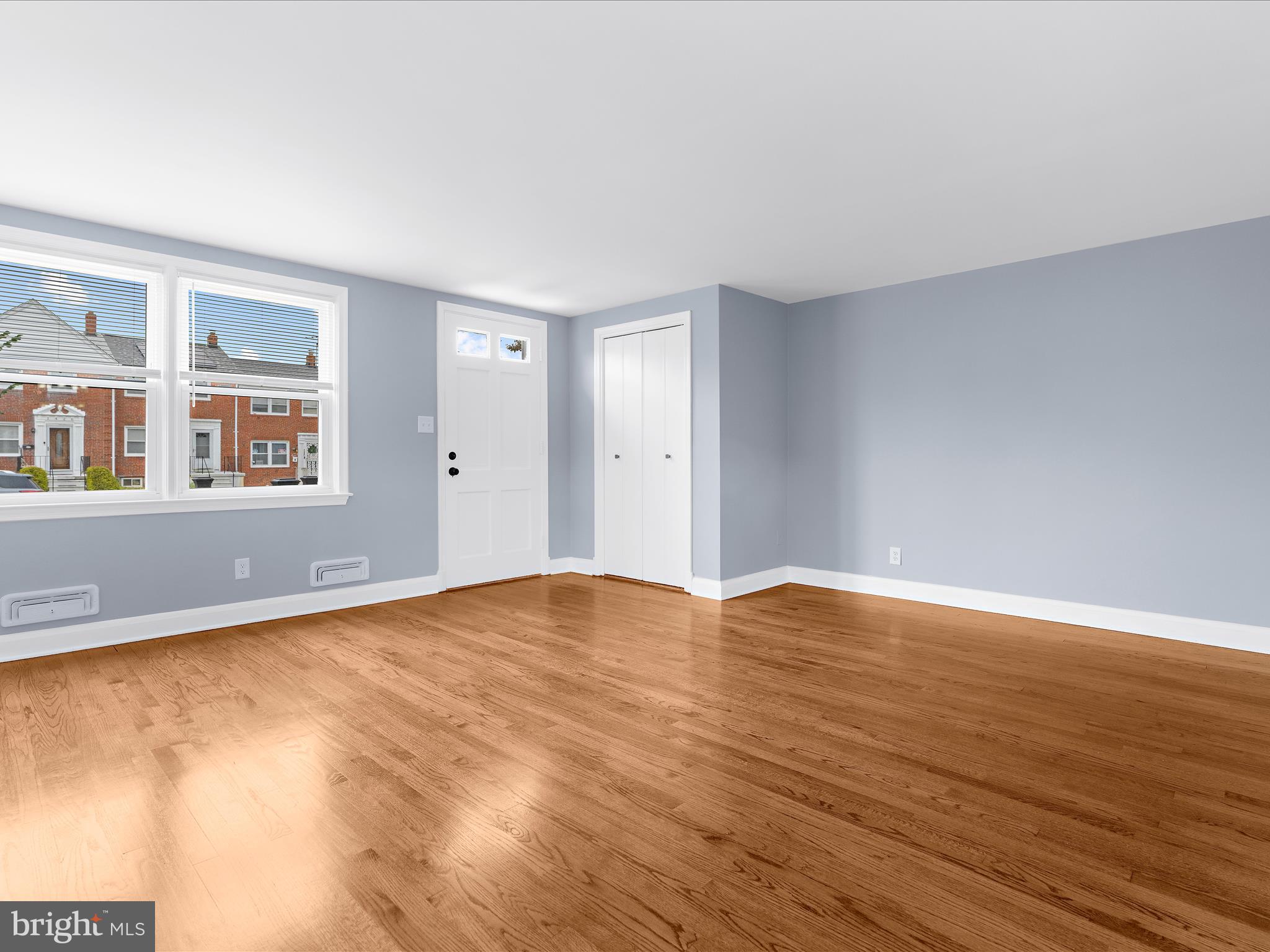 1427 Barrett Road Baltimore, MD 21207 - Photo 8 of 40 a view of an empty room with wooden floor and a window
