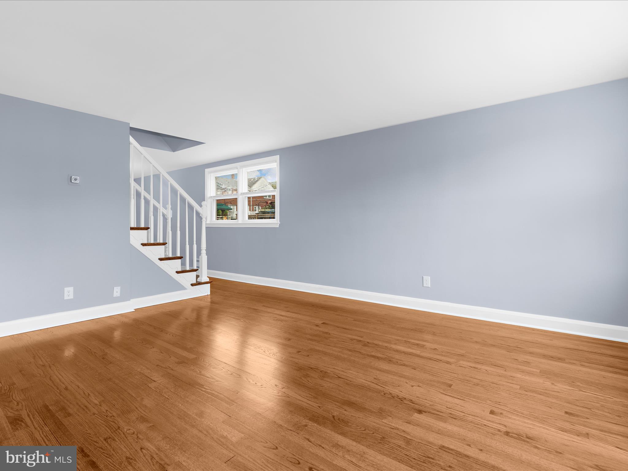 1427 Barrett Road Baltimore, MD 21207 - Photo 9 of 40 a view of an empty room with wooden floor and stairs
