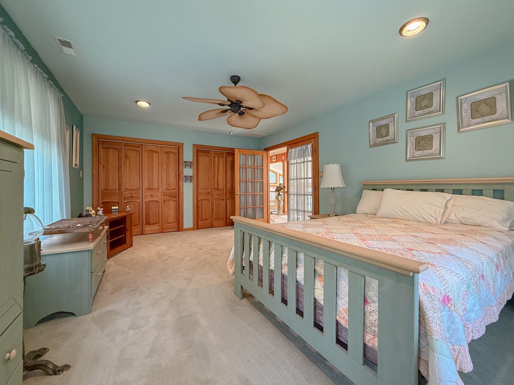 13581 Solitude Trail Machipongo, VA 23405 - Photo 20 of 51 a bedroom with furniture and windows